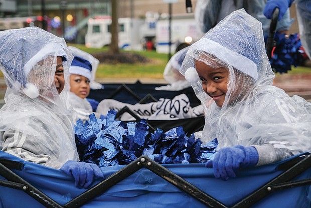 Raindrops failed to dampen the smiles worn by Shailyn Woodson and Kennedy Johnson, both 4. The girls, members of Sparkle Cheer and Dance, were among dozens of participants Dec. 3 in the annual Dominion Energy Christmas Parade.