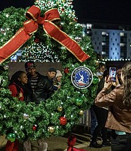 Richmond residents gather at the RVA Illuminates Christmas Lights event at Kanawha Plaza on Friday, Dec. 2.