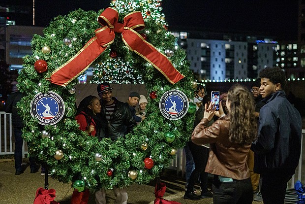 Richmond residents gather at the RVA Illuminates Christmas Lights event at Kanawha Plaza on Friday, Dec. 2.