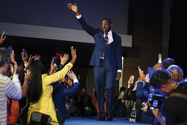 Democratic Sen. Raphael Warnock speaks during a runoff election night watch party, Tuesday, Dec. 6, in Atlanta. Sen. Warnock defeated Republican challenger Herschel Walker in the election in Georgia.