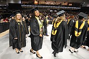 Alicia Jones of Suffolk, right center, was among the 2,450 excited graduates at VCU’s December commencement.
