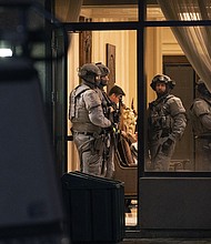 York Regional Police tactical officers stand in the lobby of a condominium in Vaughan, Ontario, on December 18. Five people and a suspect are dead after a shooting in the building, police said.
Mandatory Credit:	Arlyn McAdorey/AP