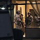 York Regional Police tactical officers stand in the lobby of a condominium in Vaughan, Ontario, on December 18. Five people and a suspect are dead after a shooting in the building, police said.
Mandatory Credit:	Arlyn McAdorey/AP