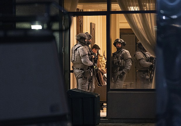 York Regional Police tactical officers stand in the lobby of a condominium in Vaughan, Ontario, on December 18. Five people and a suspect are dead after a shooting in the building, police said.
Mandatory Credit:	Arlyn McAdorey/AP