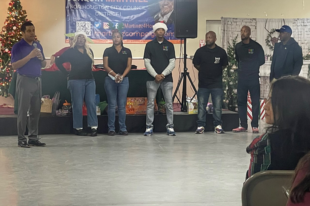 Joaquin Martinez, Director of Community Affairs for the City of Houston (left), representatives from the DMF Group Foundation (center), and Bryan Smart, Founder & CEO of SmartScaping (right) welcome seniors to today’s Holiday Luncheon.