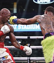 Errol Spence Jr., right, lands a punch on Yordenis Ugas, from Cuba, during a world welterweight championship boxing match Saturday, April 16, 2022, in Arlington, Texas.