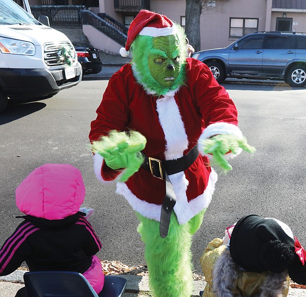 The Grinch who Stole Christmas appears to be in a good mood and the youngsters of the Friends Association for Children in Gilpin Court are just as excited to wave to him Tuesday during their annual Holiday Vehicle Parade. Other parade participants included the Victory 7 Mustang Club, Richmond Police Department, members of Richmond City Council and School Board and the Richmond Public Schools Lit Limo, who had Santa waving from a bus window.