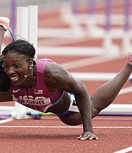 Nia Ali, of the United States, falls while competing in a heat in the women’s 100-meter hurdles at the World Athletics Championships on Saturday, July 23, in Eugene, Ore.