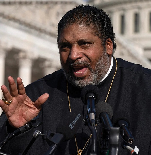 The Rev. William Barber II of the Poor People’s Campaign talks about the need for the “Build Back Better” plan, voting rights, health care, immigrant rights and action on climate change, during a news conference in Oct. 2021 on Capitol Hill in Washington.