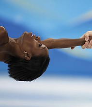 Vanessa James and Eric Radford, of Canada, compete in the pairs short program during the figure skating competition at the 2022 Winter Olympics, Friday, Feb. 18, in Beijing.