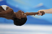 Vanessa James and Eric Radford, of Canada, compete in the pairs short program during the figure skating competition at the 2022 Winter Olympics, Friday, Feb. 18, in Beijing.