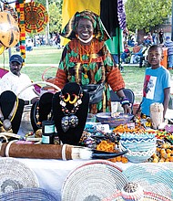 Awas, owner of Awa’s African Art, displays her baskets, jewelry, furniture and other wares during Elegba Folklore Society’s 31st Annual Down Home Family Reunion, A Celebration of African American Folklife on Aug. 20 at Abner Clay Park.