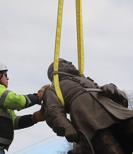Team Henry Enterprises employees remove the A.P. Hill statue at the intersection of Hermitage and Laburnum on Dec. 12. The statue of the fallen Civil War general was the last to stand on City of Richmond property since the removal of other Confederate statues began in 2020.