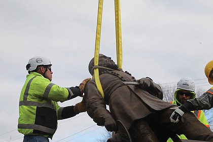Team Henry Enterprises employees remove the A.P. Hill statue at the intersection of Hermitage and Laburnum on Dec. 12. The statue of the fallen Civil War general was the last to stand on City of Richmond property since the removal of other Confederate statues began in 2020.