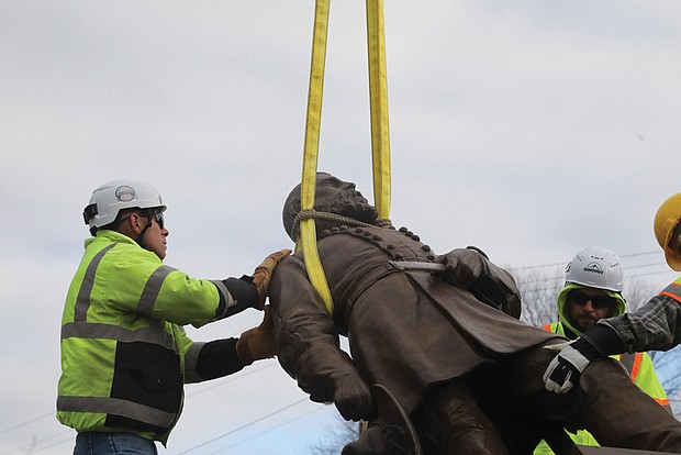 Team Henry Enterprises employees remove the A.P. Hill statue at the intersection of Hermitage and Laburnum on Dec. 12. The statue of the fallen Civil War general was the last to stand on City of Richmond property since the removal of other Confederate statues began in 2020.