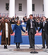 Newly sworn-in Gov. Glenn A. Youngkin, third from right, caps off the inaugural ceremony with a prayer for the Commonwealth he delivered on Jan. 15 with his fellow GOP top office holders and their spouses. They are, from left, Terence Sears, and his wife, Lt. Gov. Winsome Earle-Sears; First Lady Suzanne Youngkin; Attorney General Jason Miyares and his wife, Page Atkinson Miyares.
