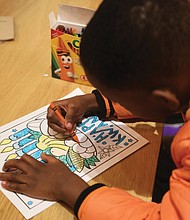 Daniel-Oleg Imisioluwa Ogunjima, 6, enjoys coloring during a Dec. 27 Kwanzaa celebration at Hardywood’s Ownby Lane location. During the week of Kwanzaa, Dec. 26 through Jan. 1, families and communities come together to share a feast, to honor the ancestors, affirm the bonds between them, and celebrate African and African-American culture.