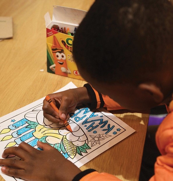 Daniel-Oleg Imisioluwa Ogunjima, 6, enjoys coloring during a Dec. 27 Kwanzaa celebration at Hardywood’s Ownby Lane location. During the week of Kwanzaa, Dec. 26 through Jan. 1, families and communities come together to share a feast, to honor the ancestors, affirm the bonds between them, and celebrate African and African-American culture.