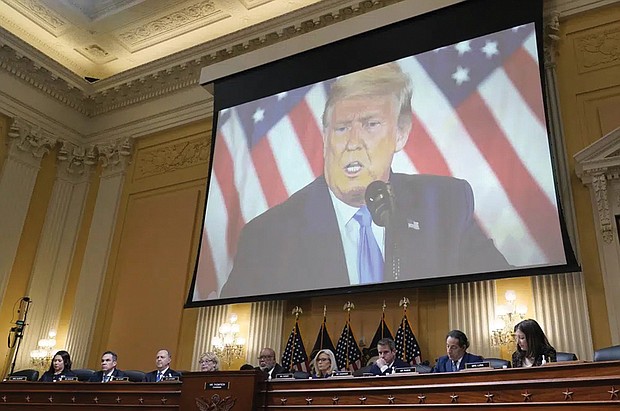 Former President Donald Trump is shown on a screen as the House select committee investigating the Jan. 6 attack holds its final meeting Dec. 19 on Capitol Hill.