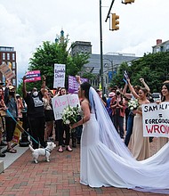 Helen Vu and her wedding party from the Cathedral of the Sacred Heart joined about 3,000 protesters who rallied in support of abortion access in Monroe Park and the streets of Downtown Richmond on May 14.