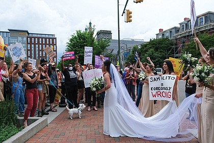 Helen Vu and her wedding party from the Cathedral of the Sacred Heart joined about 3,000 protesters who rallied in support of abortion access in Monroe Park and the streets of Downtown Richmond on May 14.