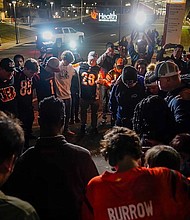 Fans gather outside the University of Cincinnati Medical Center in Cincinnati, where Buffalo Bills' Damar Hamlin was taken after collapsing on the field during an NFL football game against the Cincinnati Bengals Monday night.
Mandatory Credit:	Jeff Dean/AP