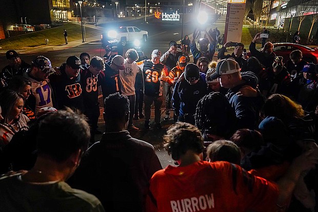Fans gather outside the University of Cincinnati Medical Center in Cincinnati, where Buffalo Bills' Damar Hamlin was taken after collapsing on the field during an NFL football game against the Cincinnati Bengals Monday night.
Mandatory Credit:	Jeff Dean/AP