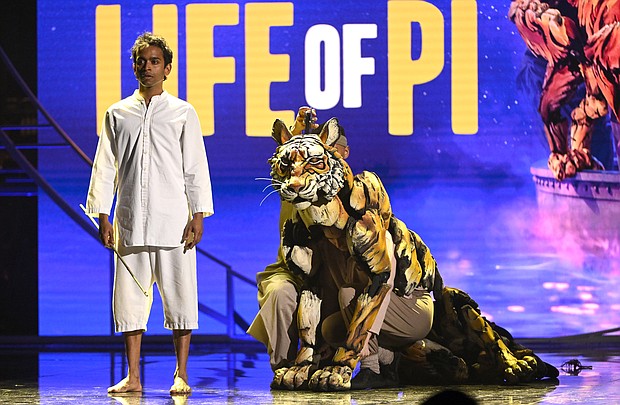 Hiran Abeysekera (left) performs alonside the several puppeteers who power Richard Parker the Bengal Tiger at the 2022 Olivier Awards.
Mandatory Credit:	Jeff Spicer/Getty Images