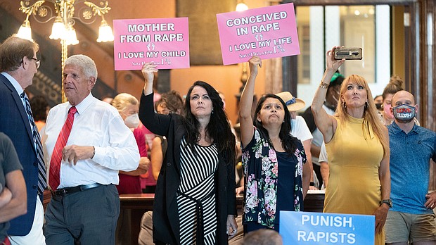 Protesters hold signs inside the South Carolina Statehouse as lawmakers debate an abortion ban in August, 2022.
Mandatory Credit:	Sean Rayford/SOPA Images/LightRocket via Getty Images