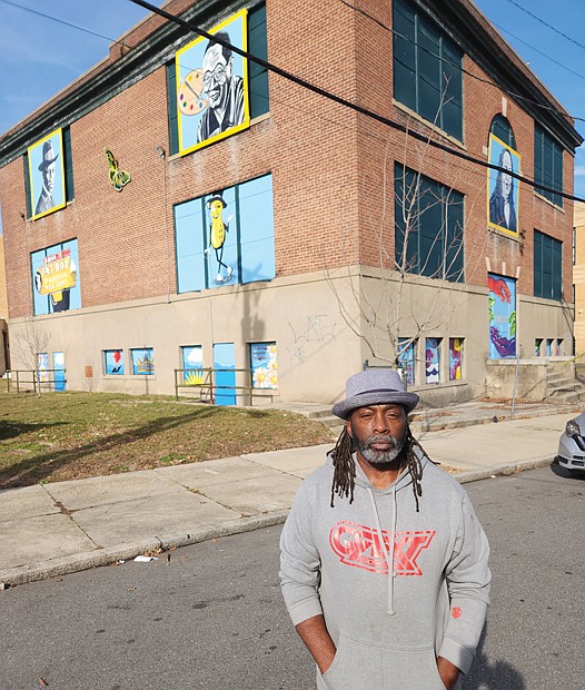 Richmond artist Sir James Thornhill poses in front of the array of 26 murals he has installed on the former Baker Elementary School on St. John Street in Gilpin Court that he once attended. Included are three tribute paintings of the late acting great Charles Gilpin, for whom the community is named; the late Lillie Estes, a longtime activist and organizer in Gilpin; and retired Richmond arts teacher Samuel Banks, who once taught at the building. This building, though vacant, is being targeted as a youth center. The remainder of the former school is now filled with apartments for seniors.