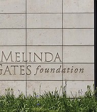 A person walks by the headquarters of the Bill and Melinda Gates Foundation on April 27, 2018, in Seattle. The Bill & Melinda Gates Foundation published its annual letter Jan. 17, which outlines the organization’s priorities and announced its $8.3 billion budget for 2023. CEO Mark Suzman, who authored the letter, raised the question of whether the foundation has too much power and influence.