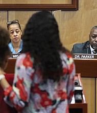 Djifa Lee, a second grade teacher at Saunders Elementary, center, stands with her daughter as she speaks in front of the Newport News School Board at the Newport News Public Schools Administration building Tuesday. Community members spoke about issues and solutions to violence in schools following the shooting at Richneck Elementary by a 6-year-old that left a teacher in critical condition.