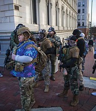 Members of the Virginia Kekoas, a Boogaloo Movement affiliated pro gun group, stand on the corner of Bank Street and N. 10th Street wearing body armor and carrying various firearms during Lobby Day on Monday at Capitol Square in Richmond. The Virginia Kekoas, a group based in the Hampton Roads area, has been active in the pro 2nd Amendment movement since 2021.