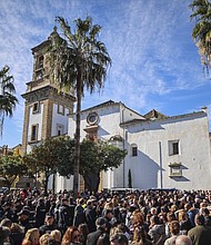 Spanish authorities believe the Moroccan suspect in a deadly machete attack at two churches in the southern port city of Algeciras  acted alone in the assault. Locals are pictured on January 26 to remember a sacristan who was killed at a church.
Mandatory Credit:	Juan Carlos Toro/AP