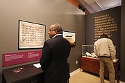 During a private reception Monday, Jan. 23, guests such as Simon Scott of Norfolk review some of the items on display.