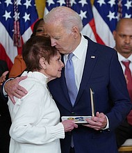 President Joe Biden awards the Presidential Citizens Medal to US Capitol Police Officer Brian D. Sicknick, whose mother Gladys Sicknick accepts on his behalf.
Mandatory Credit:	Mandel Ngan/AFP/Getty Images