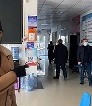 Government minders follow CNN into a village clinic.
Mandatory Credit:	CNN