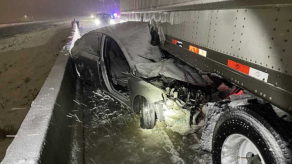 A 28-year-old woman was hospitalized early Wednesday after a semitrailer dragged her vehicle nearly eight miles after a crash.