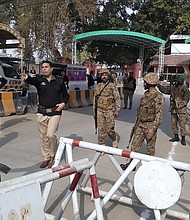 Soldiers and police officers clear the way for ambulances rushing toward the explosion site in Peshawar, Pakistan, January 30.
Mandatory Credit:	Muhammad Sajjad/AP