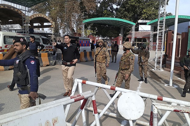 Soldiers and police officers clear the way for ambulances rushing toward the explosion site in Peshawar, Pakistan, January 30.
Mandatory Credit:	Muhammad Sajjad/AP