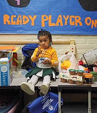 Leona Robinson, age 2, takes a break among the snacks from cheering duties in between basketball games at the Hotchkiss Community Center on Jan 27.