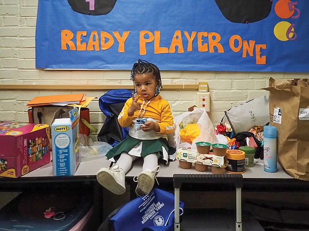 Leona Robinson, age 2, takes a break among the snacks from cheering duties in between basketball games at the Hotchkiss Community Center on Jan 27.