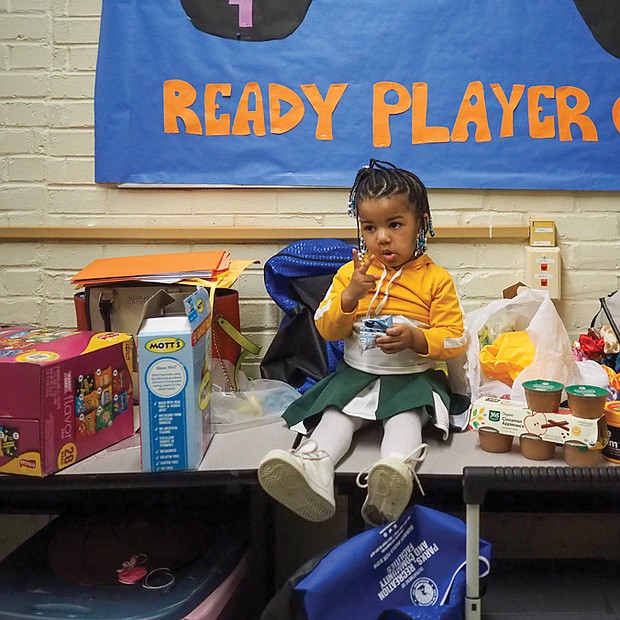 Leona Robinson, age 2, takes a break among the snacks from cheering duties in between basketball games at the Hotchkiss Community Center on Jan 27.