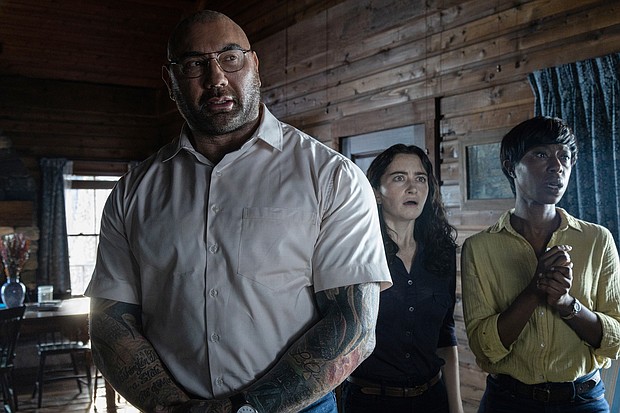 Dave Bautista, Abby Quinn and Nikki Amuka-Bird in director M. Night Shyamalan's adaptation "Knock at the Cabin."
Mandatory Credit:	Universal Pictures