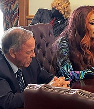 Drag performer MD Hunter, whose stage name is Athena Sinclair, testifies before a state Senate panel as state Sen. Gary Stubblefield, left, listens, at the Arkansas Capitol in Little Rock, Arkansas, on January 19.
Mandatory Credit:	Andrew DeMillo/AP