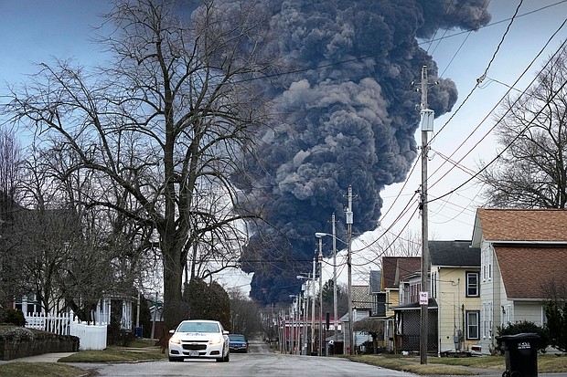 A black plume rises over East Palestine, Ohio, as a result of a controlled detonation on a derailed train Monday, February 6.
Mandatory Credit:	Gene J. Puskar/AP