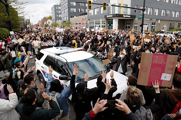 Ohio State students surround a police vehicle on April 21, 2021, while marching toward the Ohio Statehouse to protest the police shooting that killed Ma'Khia Bryant.
Mandatory Credit:	Kyle Robertson/Columbus Dispatch/USA Today Network