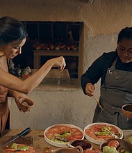 Chef Thalía Barrios García (right) drizzles the salad with the vinaigrette, while Eva Longoria adds flaky salt. "It's important to preserve this way of eating. The way that nourished our ancestors," García said.
Mandatory Credit:	CNN