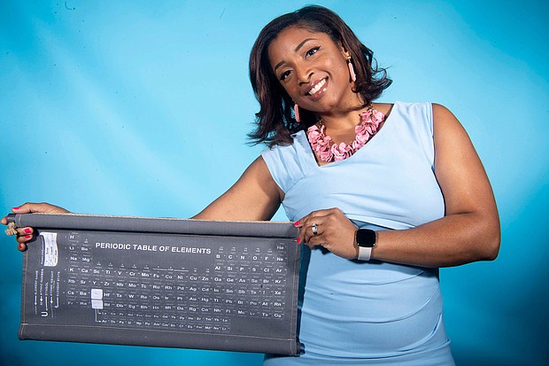 Clarice Phelps poses in 2020 with the chart used to organize the building blocks of science.
Mandatory Credit:	Calvin Mattheis/The Knoxville News Sentinel/USA Today Network