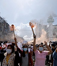 A group of women hold torches as they protest against the military coup in Yangon, Myanmar July 14, 2021.
Mandatory Credit:	Stringer/Reuters/FILE